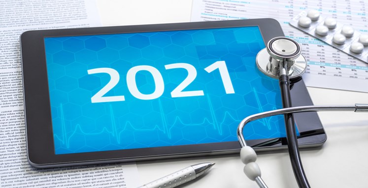 Stethoscope next to a tablet with the year 2021 on display.