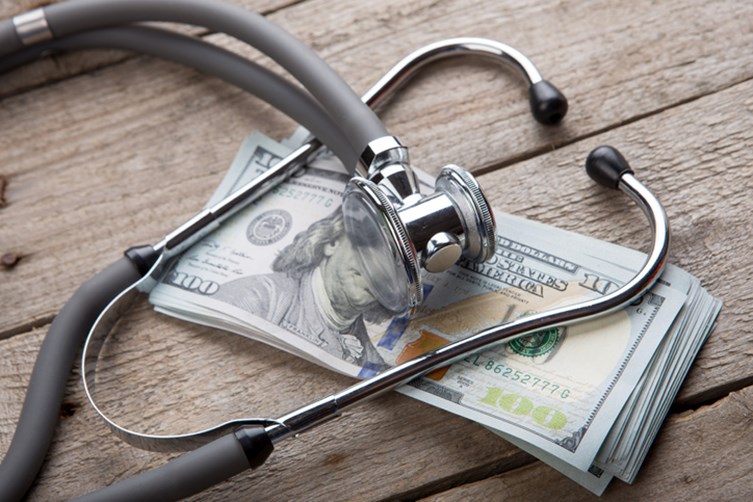 Stethoscope over money.